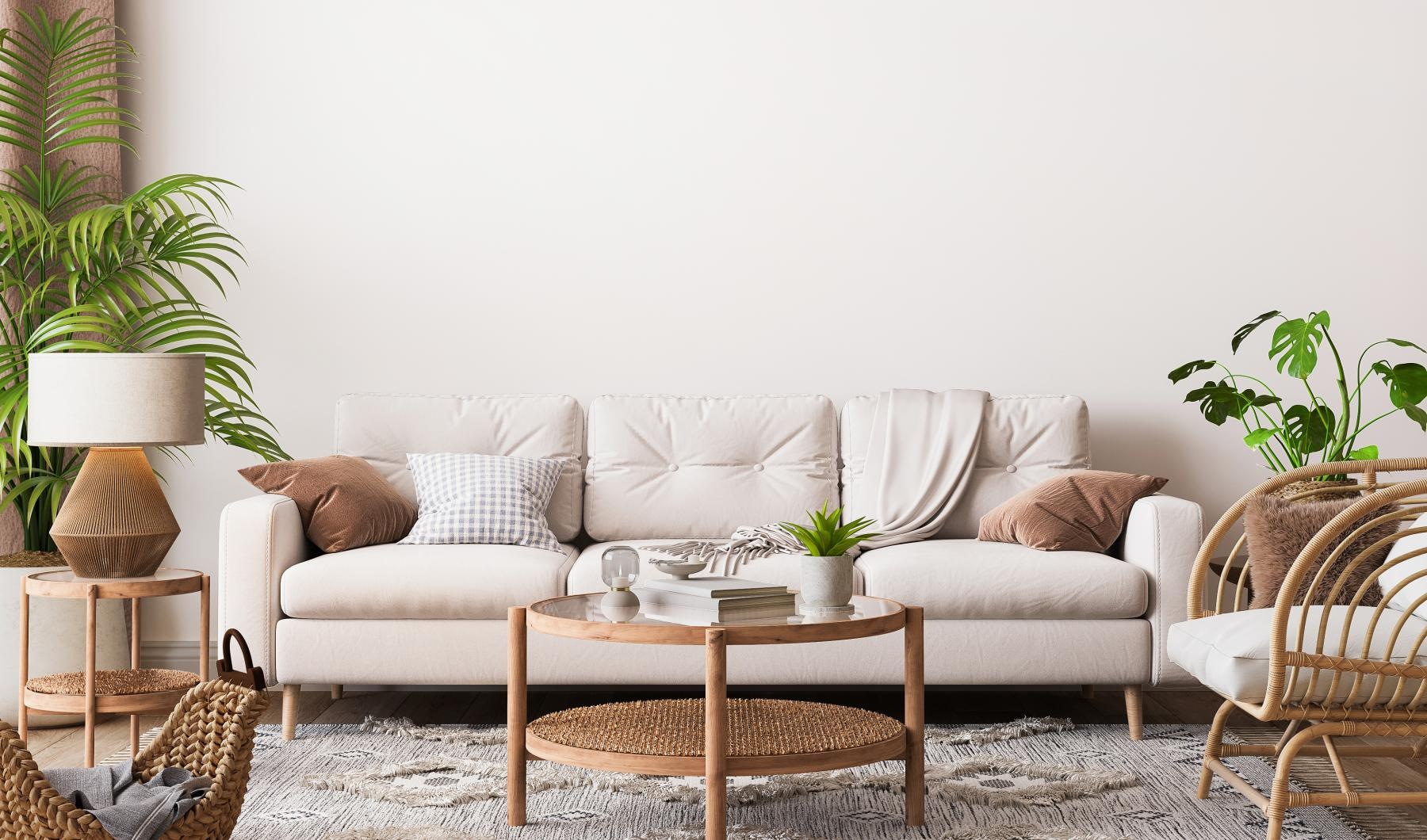 a white couch with a table and chairs in a room with plants